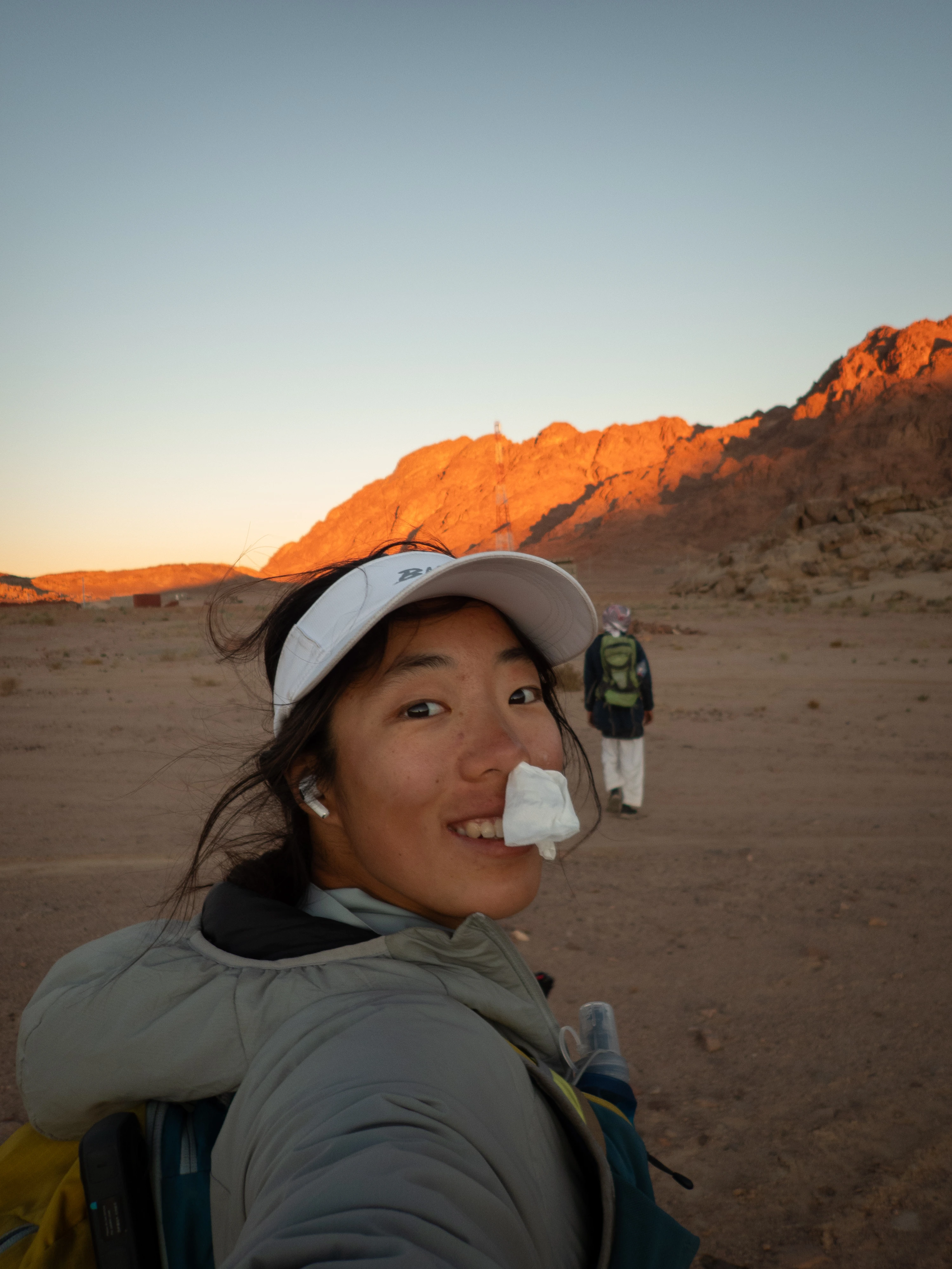 Ria looking back over her shoulder while running through dramatic terrain